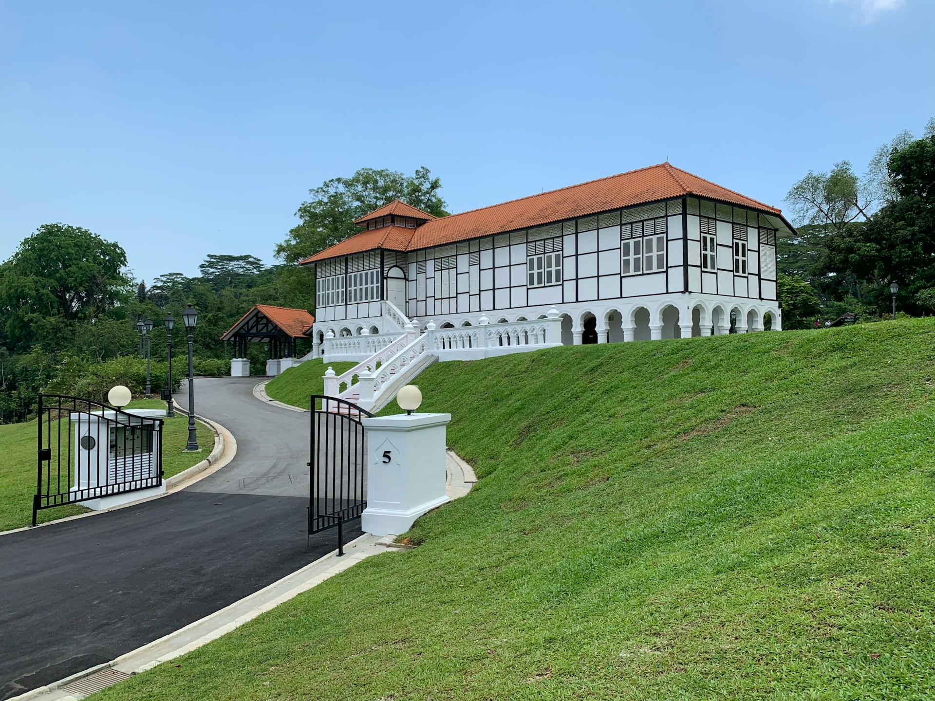 white-red-tiled-building-on-a-hill"/